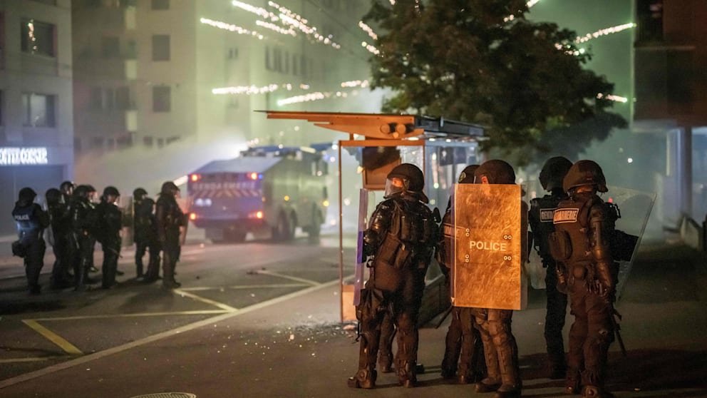 Oficerët e policisë të armatosur me mburoja dhe shkopinj sulmohen me piroteknikë